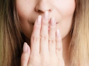 Part of face woman covering her lips with hand